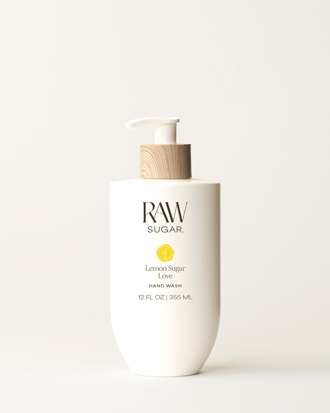 Bottle of Raw Sugar Lemon Hand Wash on a cream background, designed to help gently cleanse hands with clean ingredients.