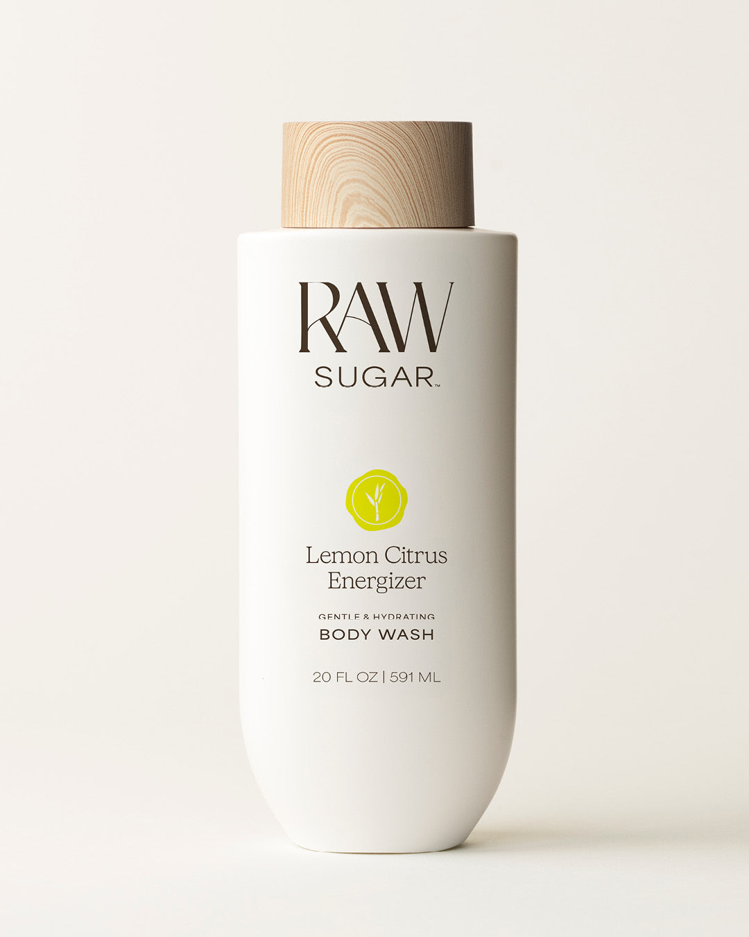 Bottle of Raw Sugar Lemon Body Wash on a cream background, designed to help gently cleanse and hydrate skin with clean ingredients.