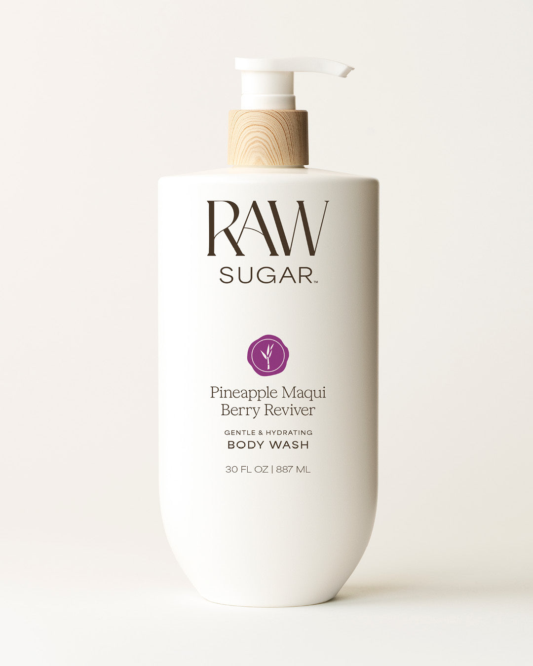 Bottle of Raw Sugar Pineapple Body Wash on a cream background, designed to help gently cleanse and hydrate skin with clean ingredients.