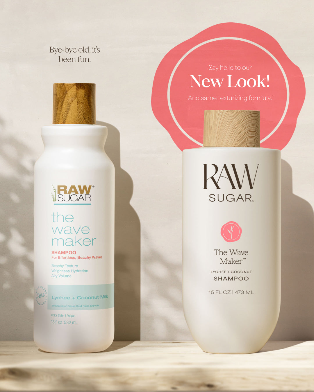 Two bottles of Raw Sugar 'The Wave Maker' shampoo on a wooden surface with a beige background.