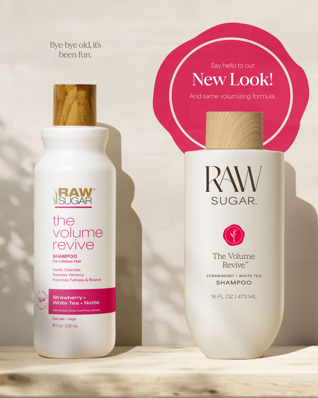 Two bottles of Raw Sugar 'The Volume Revive' shampoo on a wooden surface with a pink circular graphic in the background.