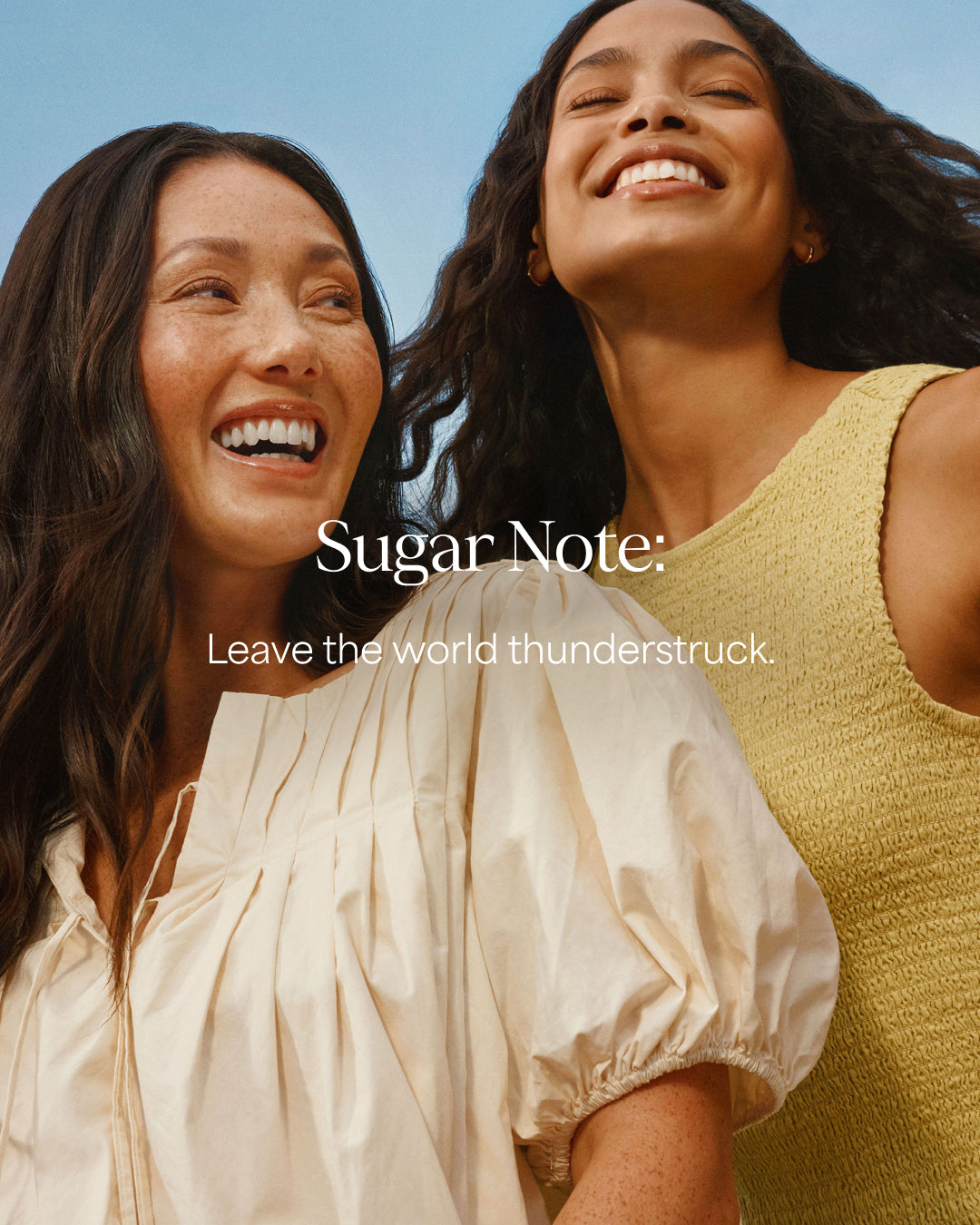 Two women smiling with 'Sugar Note' text overlay against a clear blue sky.