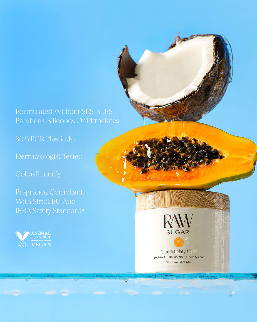 Hair mask with coconut and papaya on a blue background, designed to help nourish curly hair with clean ingredients.
