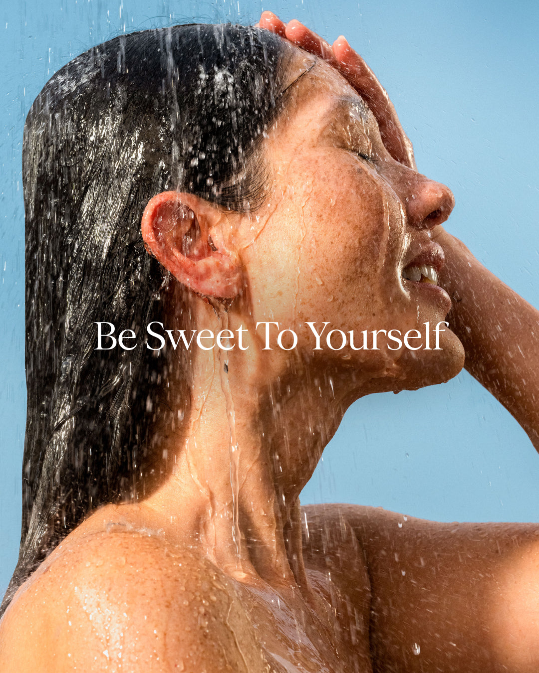 Person showering with 'Be Sweet To Yourself' text overlay