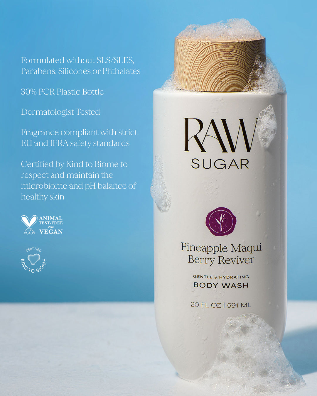 RAW Sugar Pineapple Maqui Berry Reviver body wash with a bamboo cap on a light blue background, designed to help gently cleanse and hydrate skin with clean ingredients.