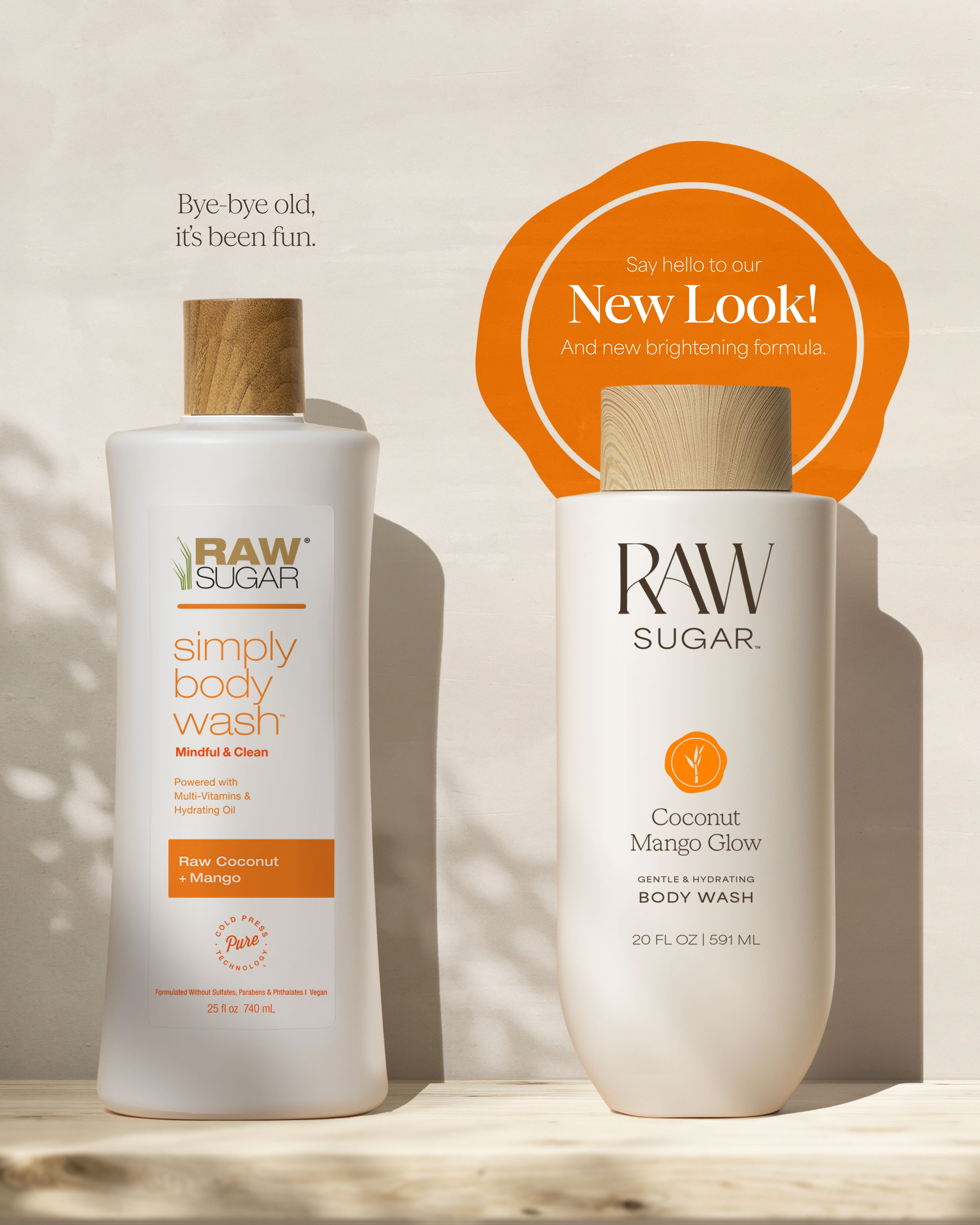 Two bottles of Raw Sugar body wash with a 'New Look' label on a neutral background designed to help gently cleanse and hydrate skin with clean ingredients.