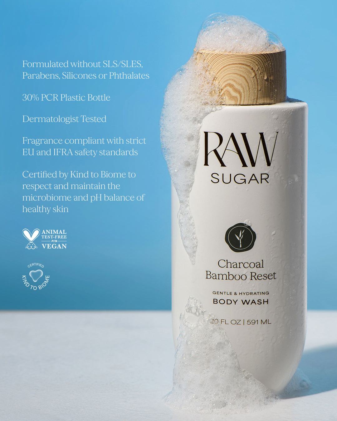 RAW Sugar Charcoal Bamboo Reset body wash with a wooden cap on a blue background