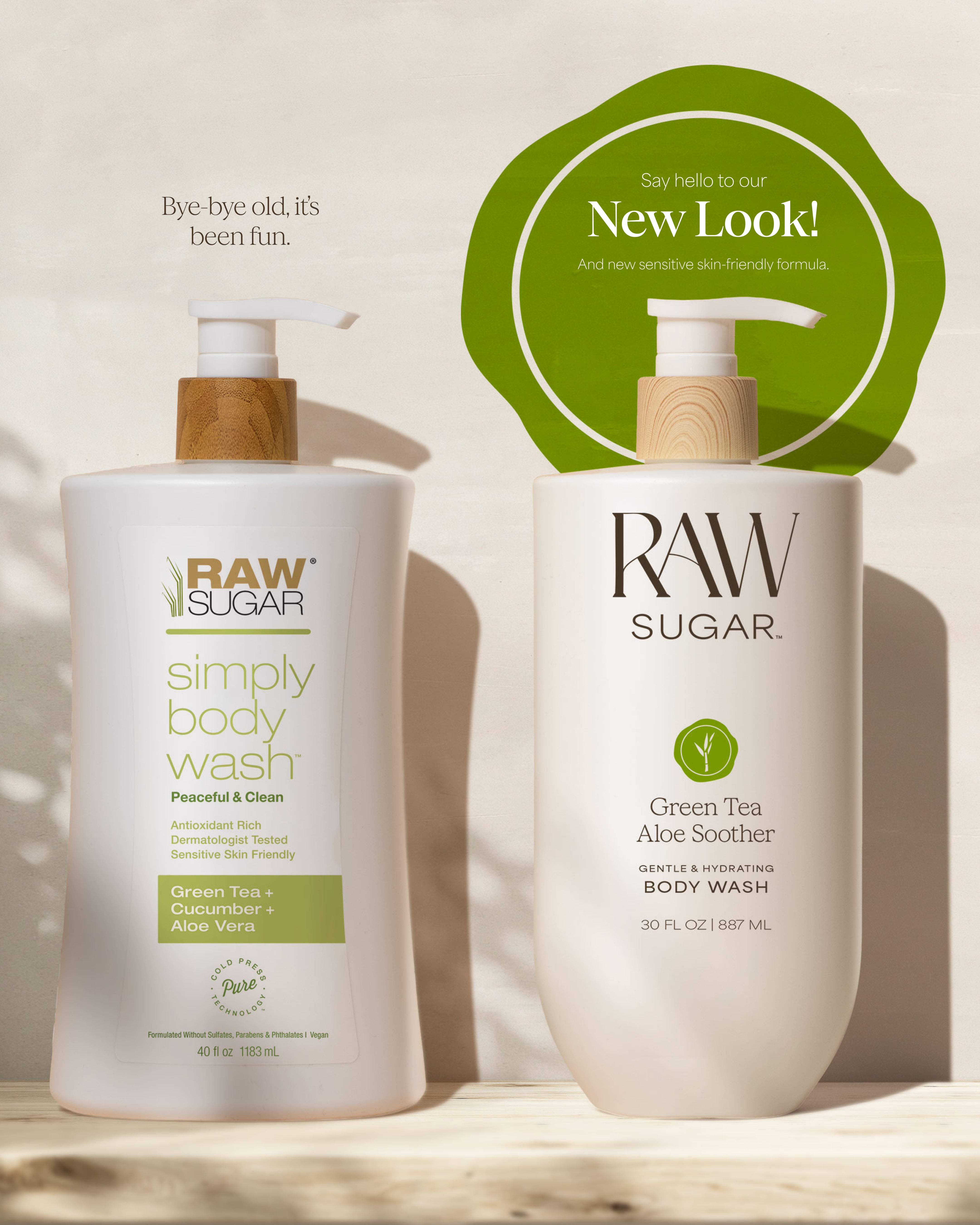 Two bottles of Raw Sugar body wash on a wooden surface with a green label indicating a new look.