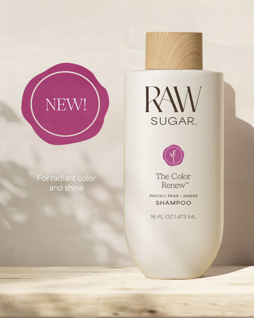 RAW SUGAR Color Renew Shampoo bottle with a 'NEW!' label on a neutral background, designed to help color-treated hair with clean ingredients.