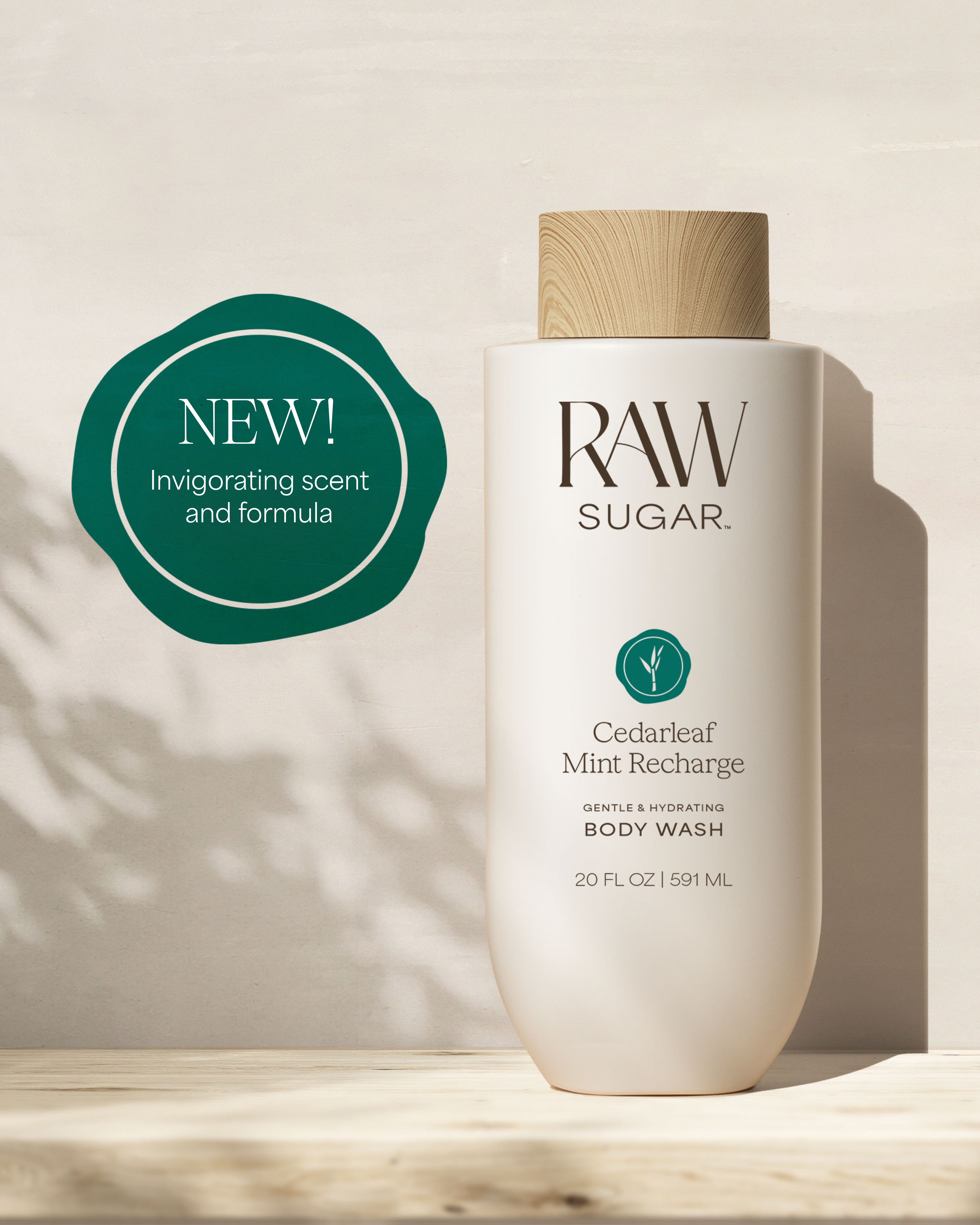 RAW Sugar body wash bottle with a green 'NEW!' label on a neutral background, designed to help gently cleanse and hydrate skin with clean ingredients.