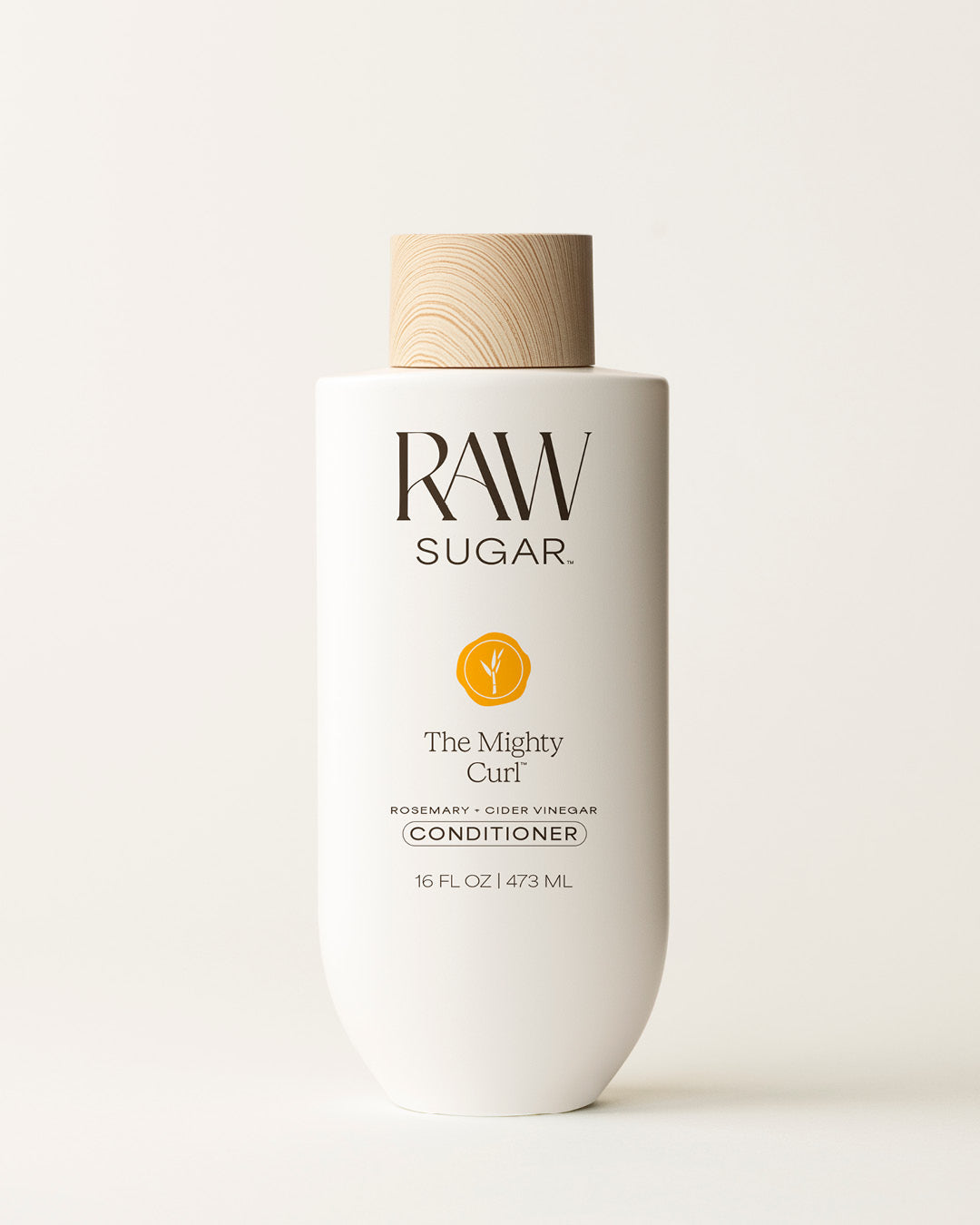 Bottle of Raw Sugar Mighty Curl Conditioner on a cream background, designed to help nourish hair with clean ingredients.