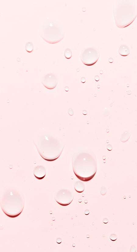 pink background with water drops on top