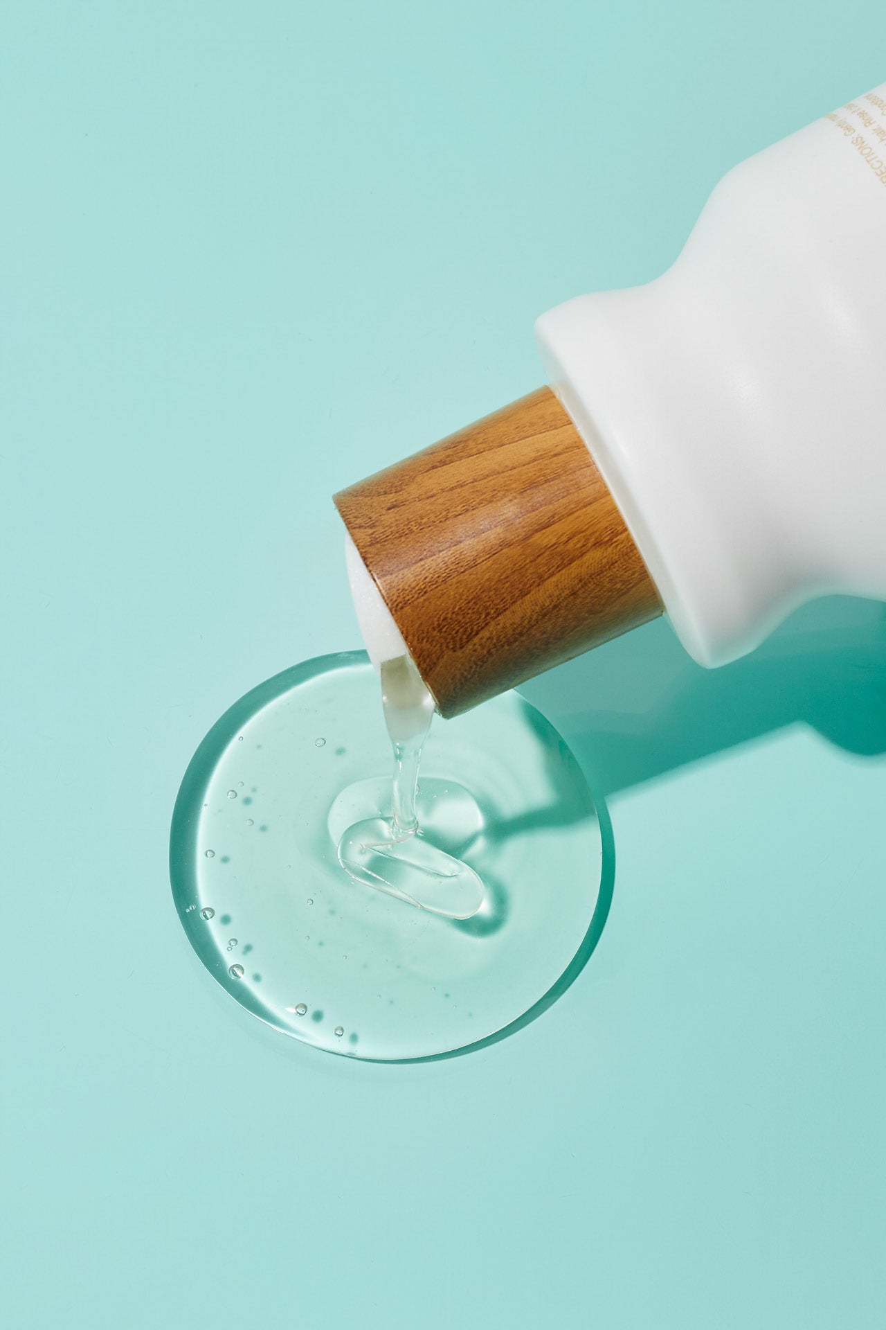 grow pro shampoo pouring on to teal background