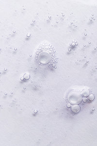 goop image of simply straight serum, bubbles on light grey background