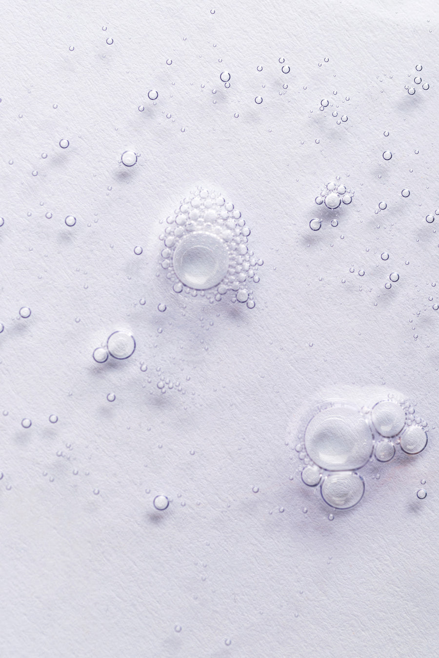 goop image of simply straight serum, bubbles on light grey background