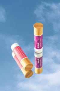 various lip balms on sky background