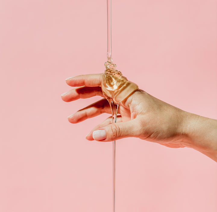 hand in front of pink background with goop on hand