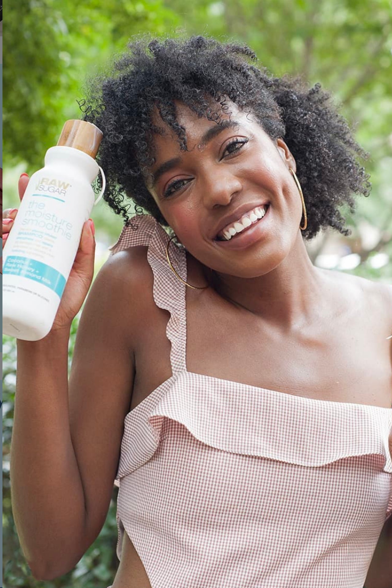 Woman holding Raw Sugar Shampoo