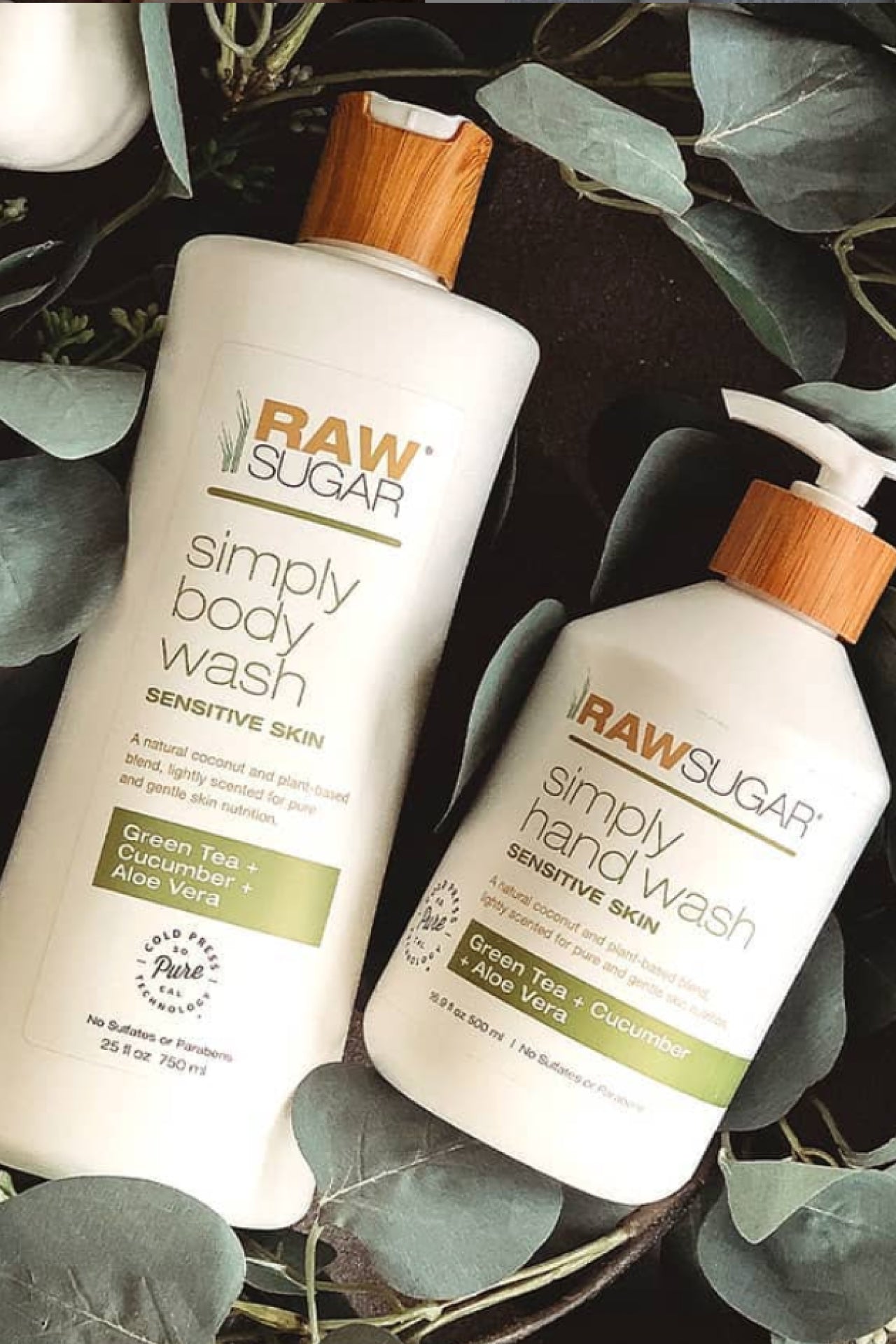 Hand and body wash laying against eucalyptus