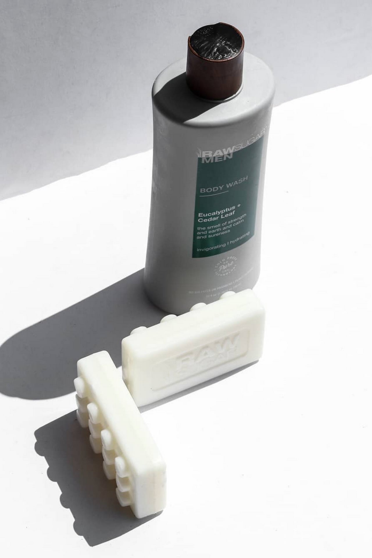 two bars of soap next to body wash