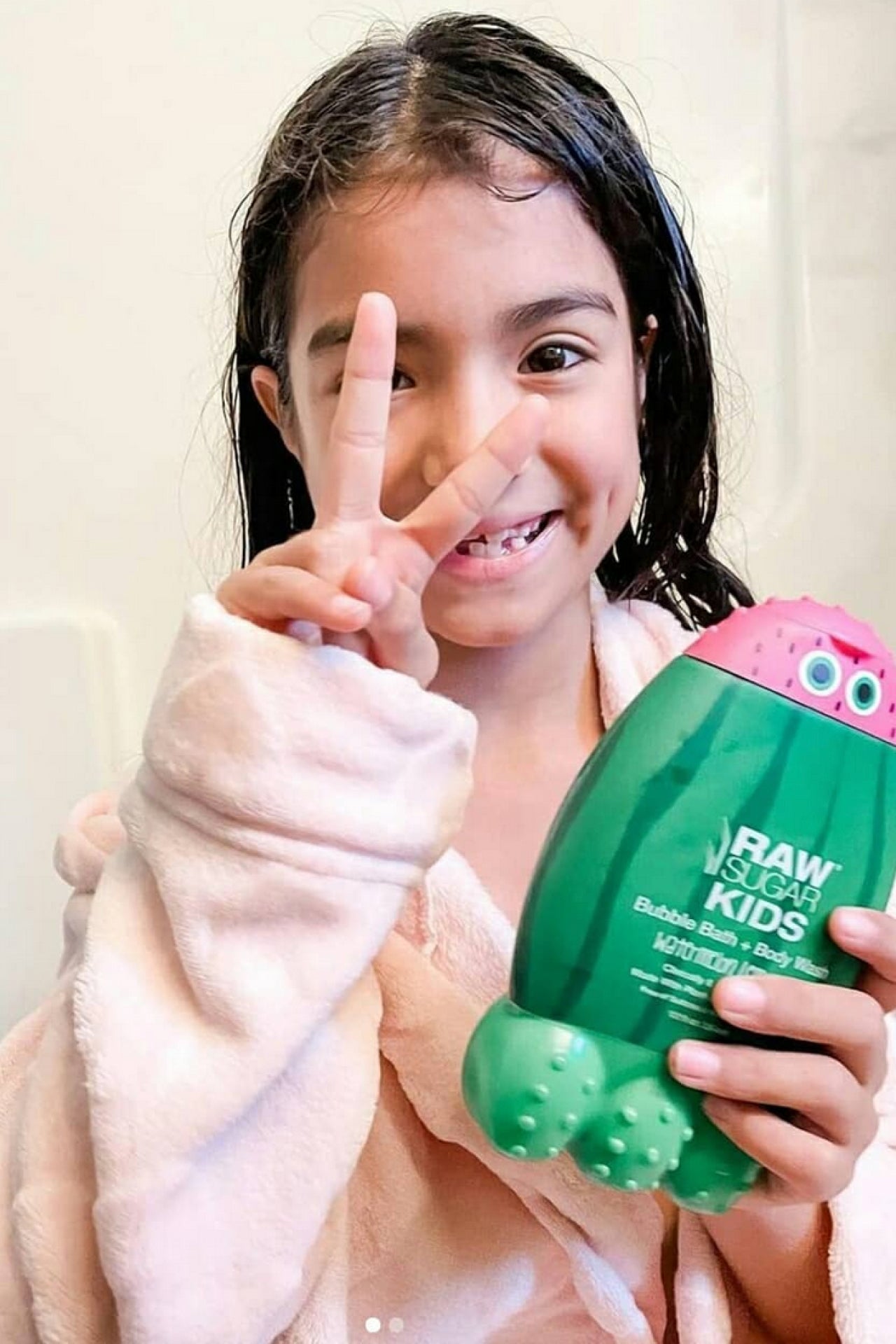 Girl in robe holding Bubble Bath