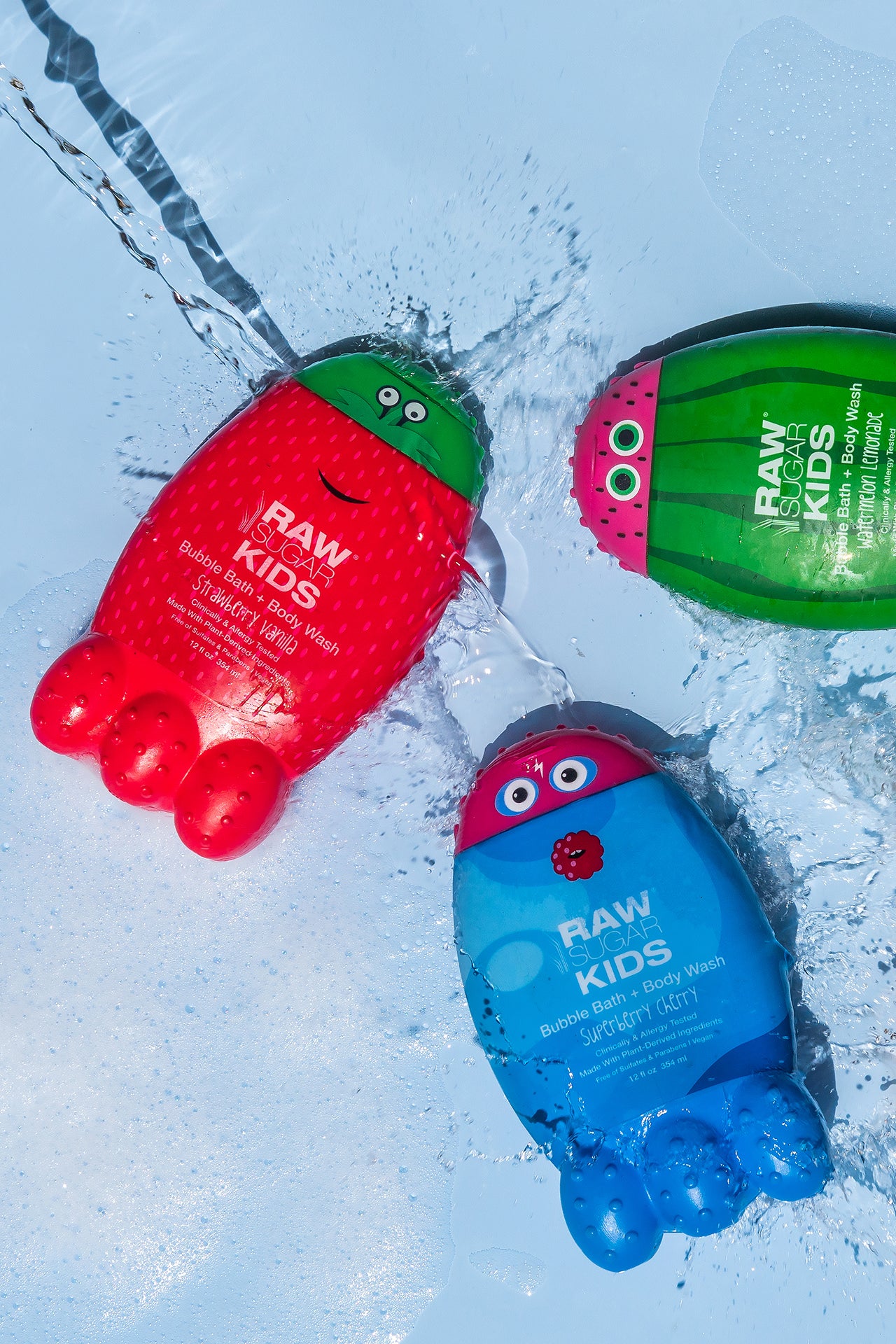 Photo of 3 Raw Sugar Kids Bubble Baths Monsters lying flat with water splashing around them