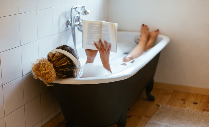 Girl reading in a bubble bath