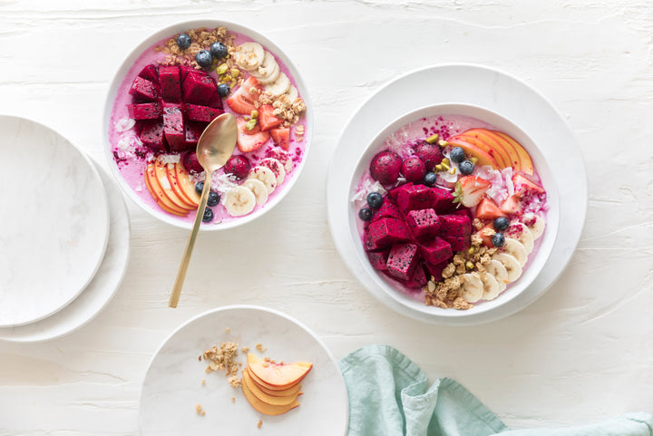 two oatmeal bowls with fruits and berries