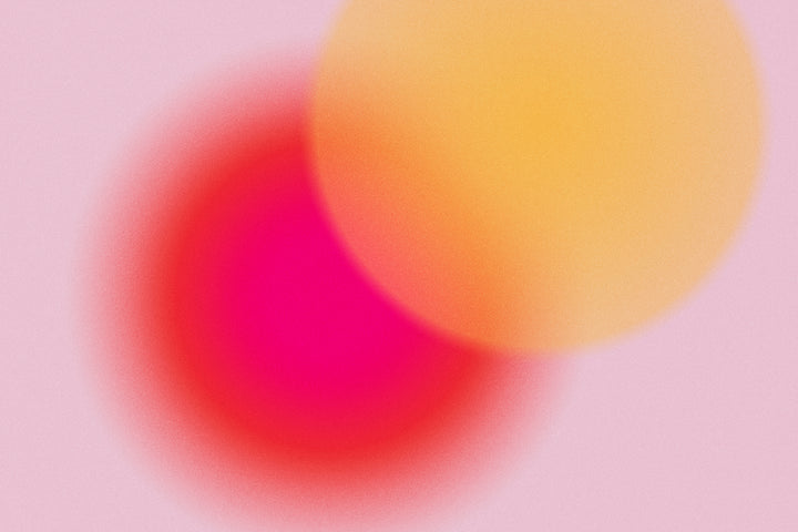 red and orange circle on pink background blurred