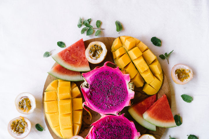 passion fruit, mango, watermelon on a board