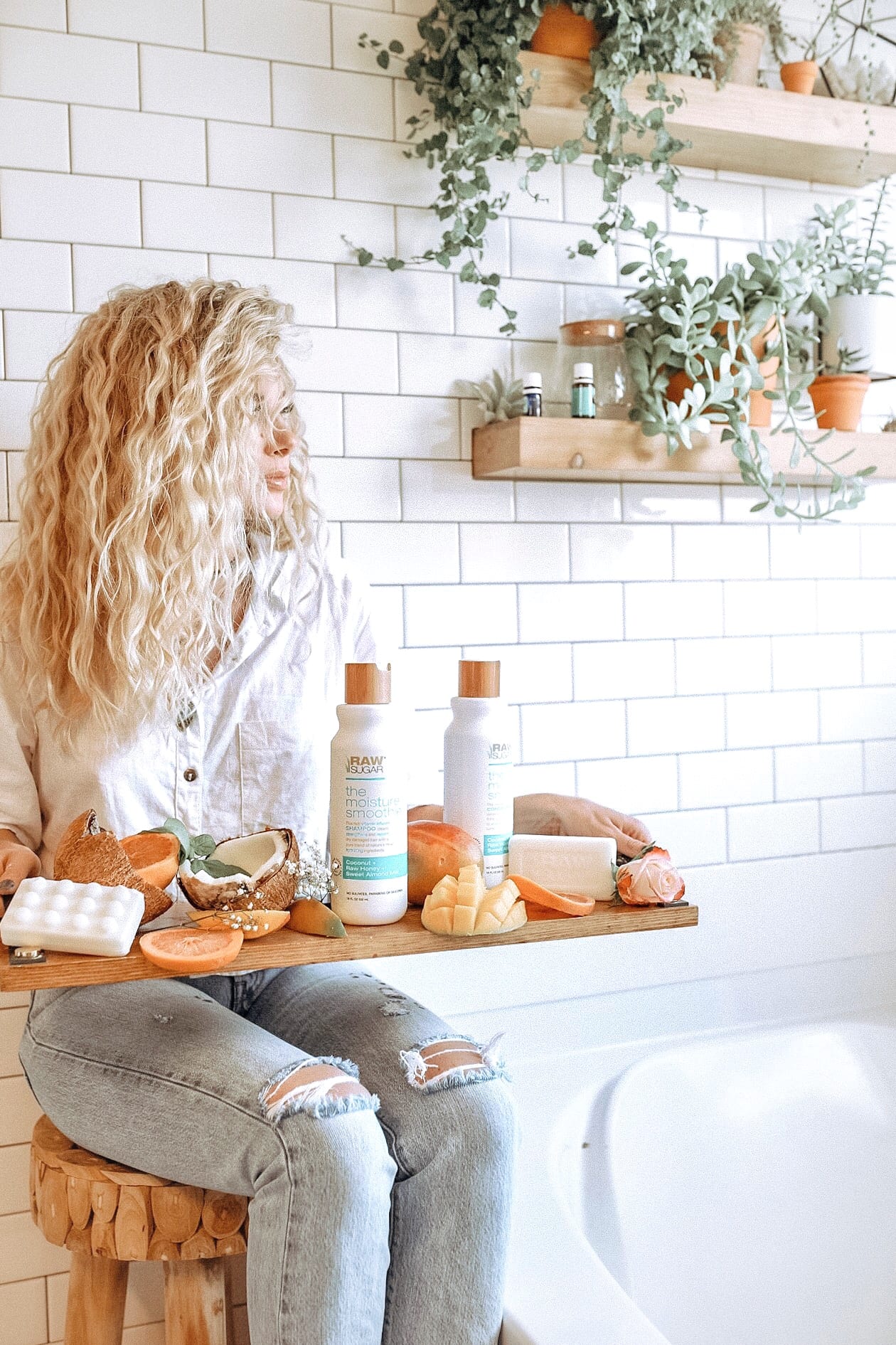 girl sitting next to bath tub witih sulfate free shampoo