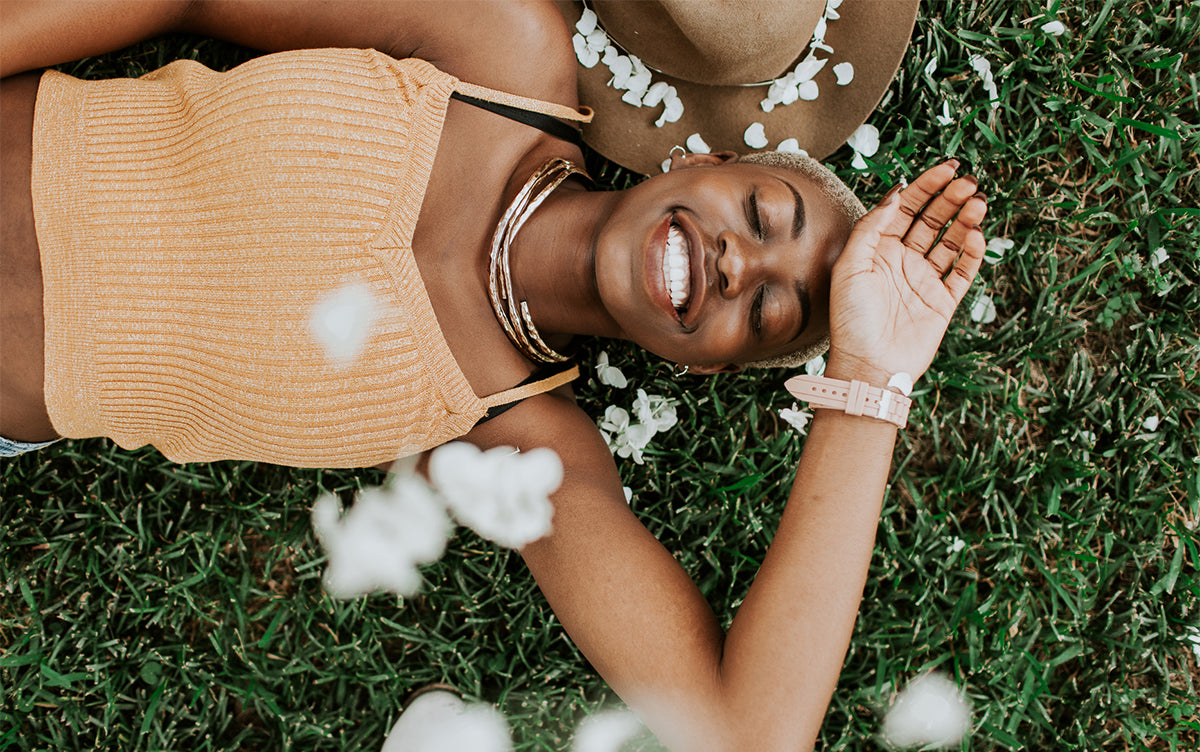 Person laying on grass happy