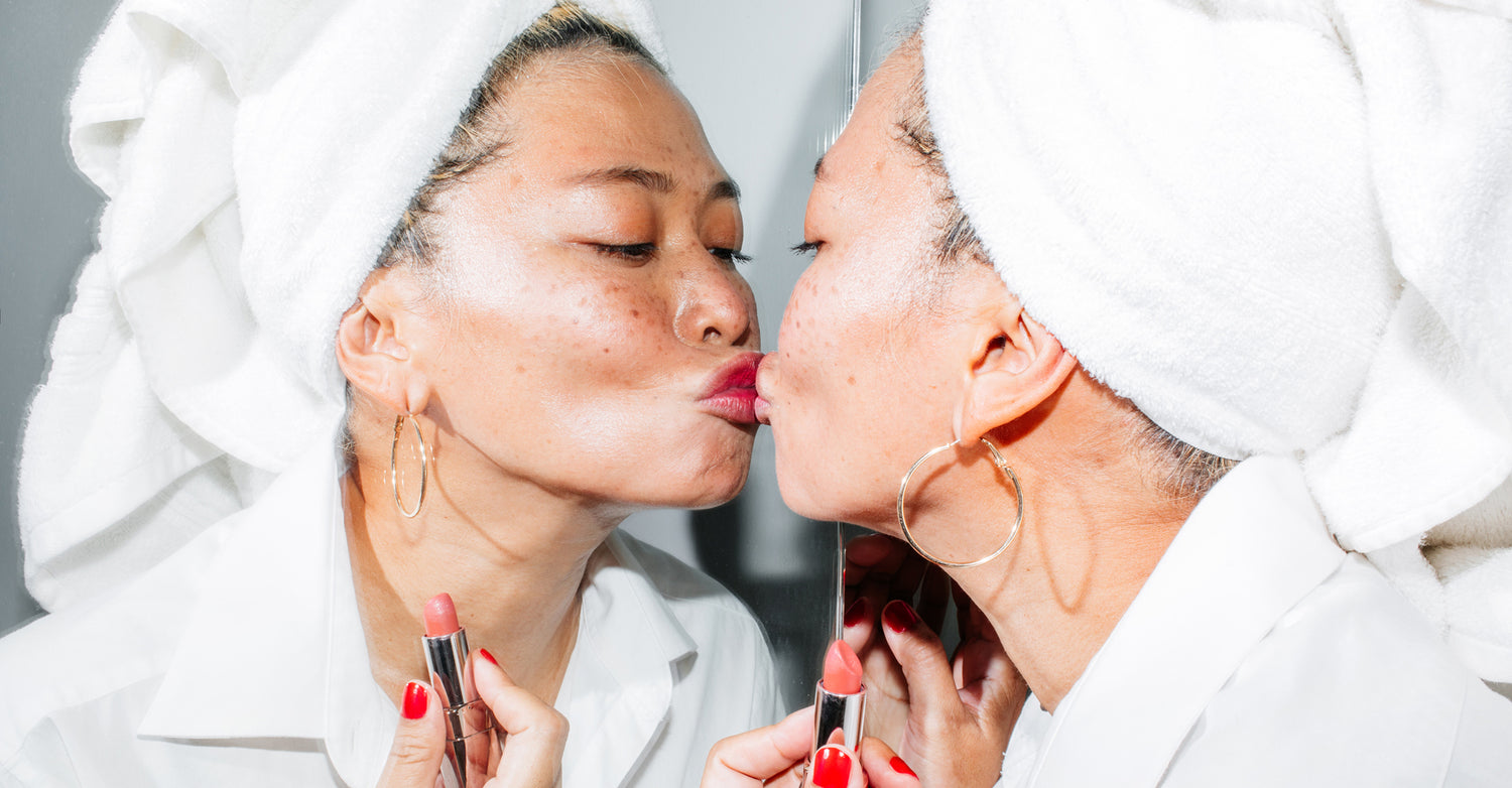 person kissing themselves in the mirror