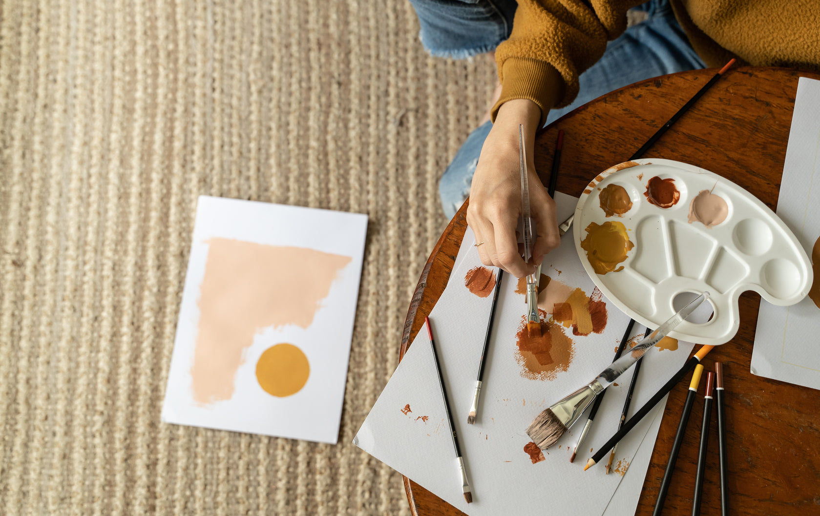 person painting with neutral colors