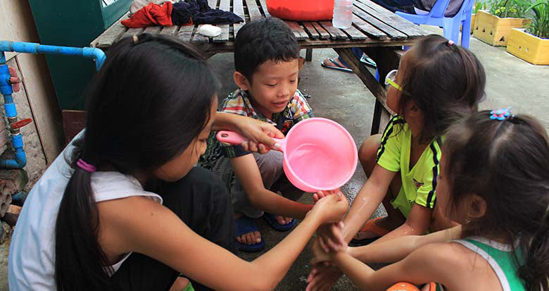 Children with water bucket