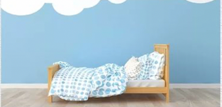 bed next to blue wall