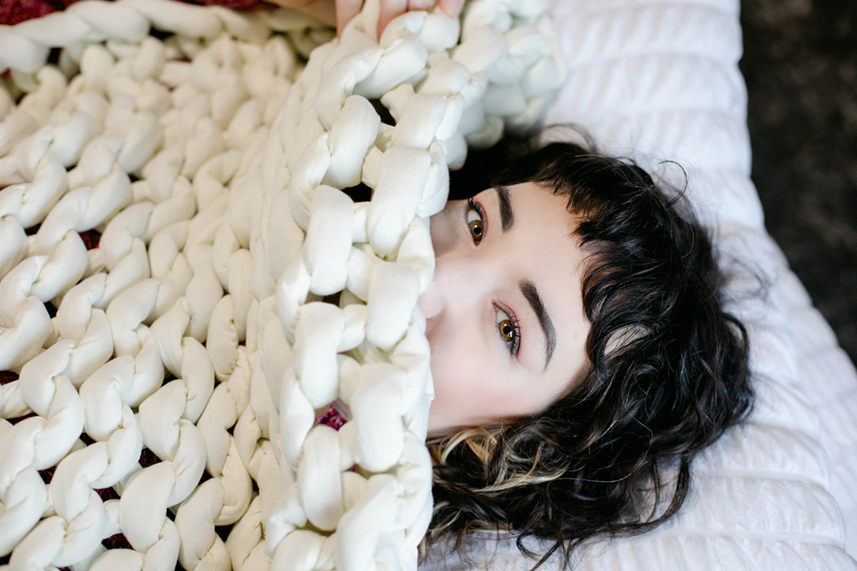woman being cozy under a blanket