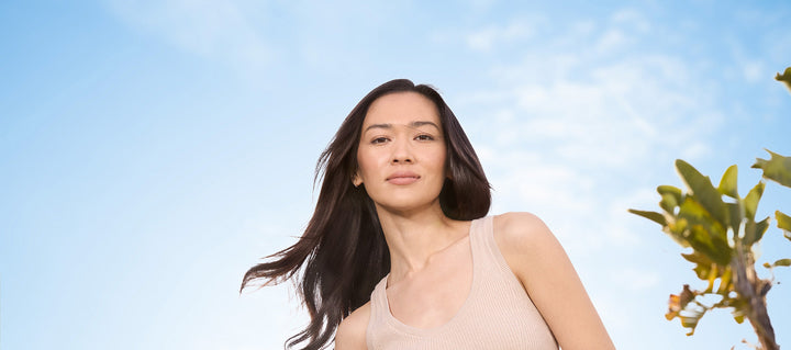 woman embracing being sensitive in front of blue sky