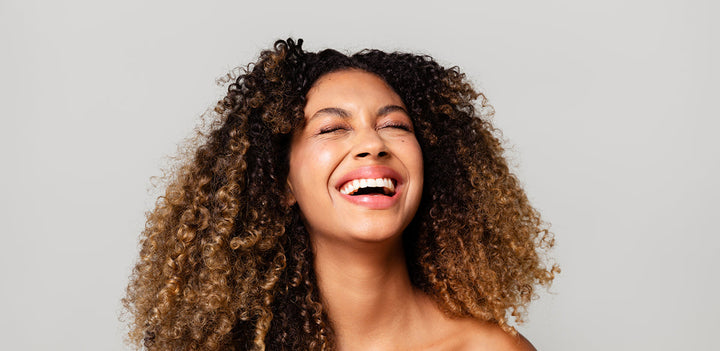 woman smiling thinking about new year's resolutions