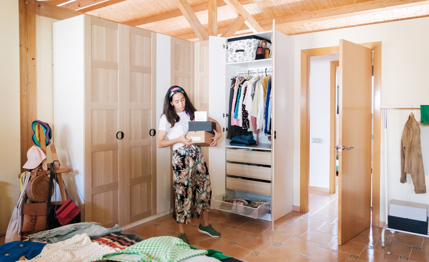 Girl holding shoe boxes from closet