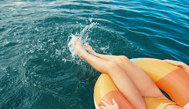 person relaxing on a floaty in open water
