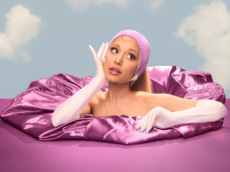 Ariana Grande in gloves, headband, and satin costume