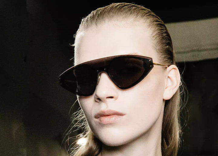 woman with sunglasses and slicked back hair