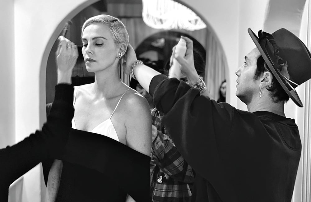 hair stylist spraying hair spray in hair