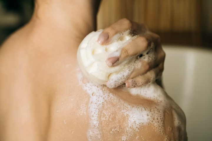 Person using soap lathering shoulder