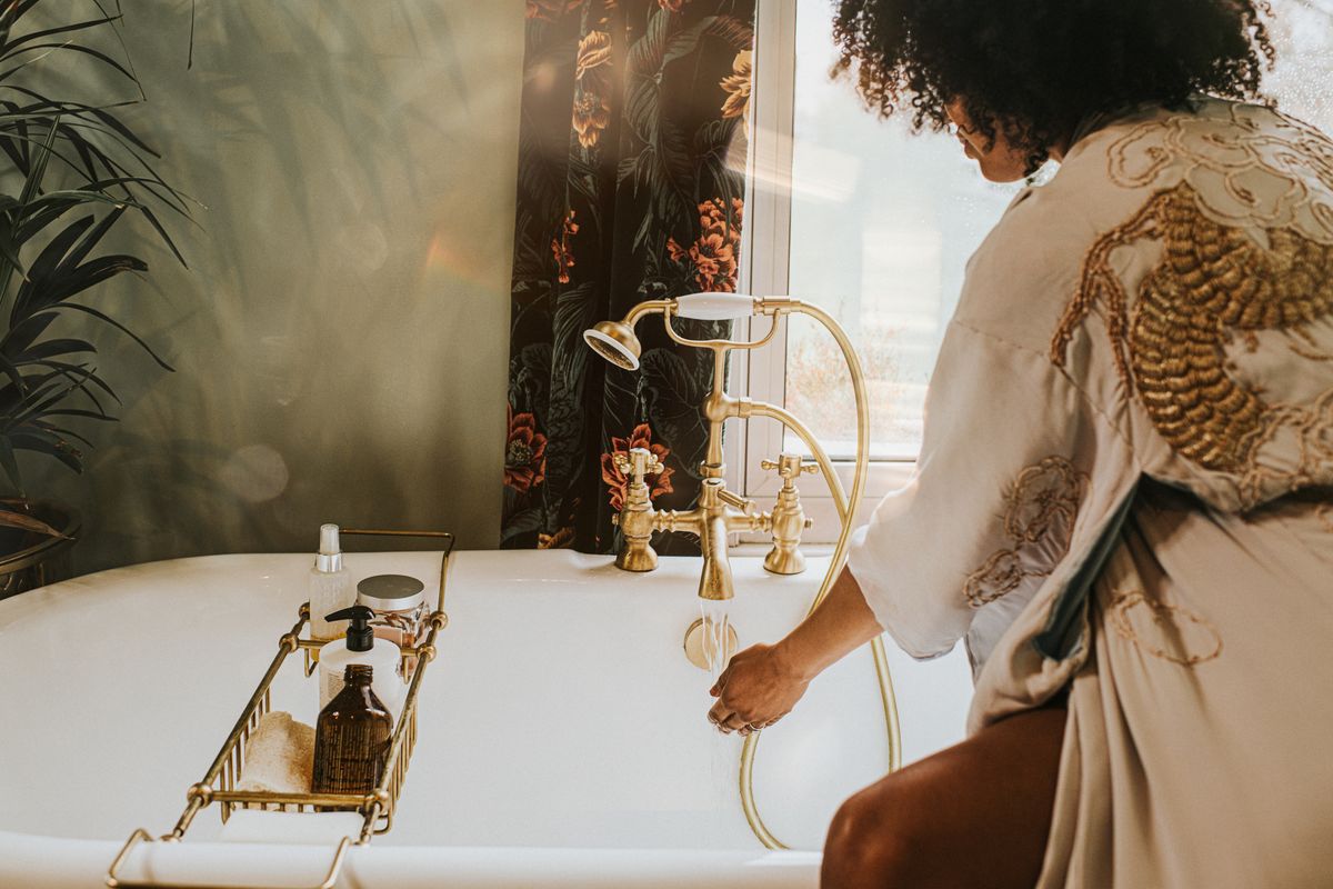 woman in robe making a bath