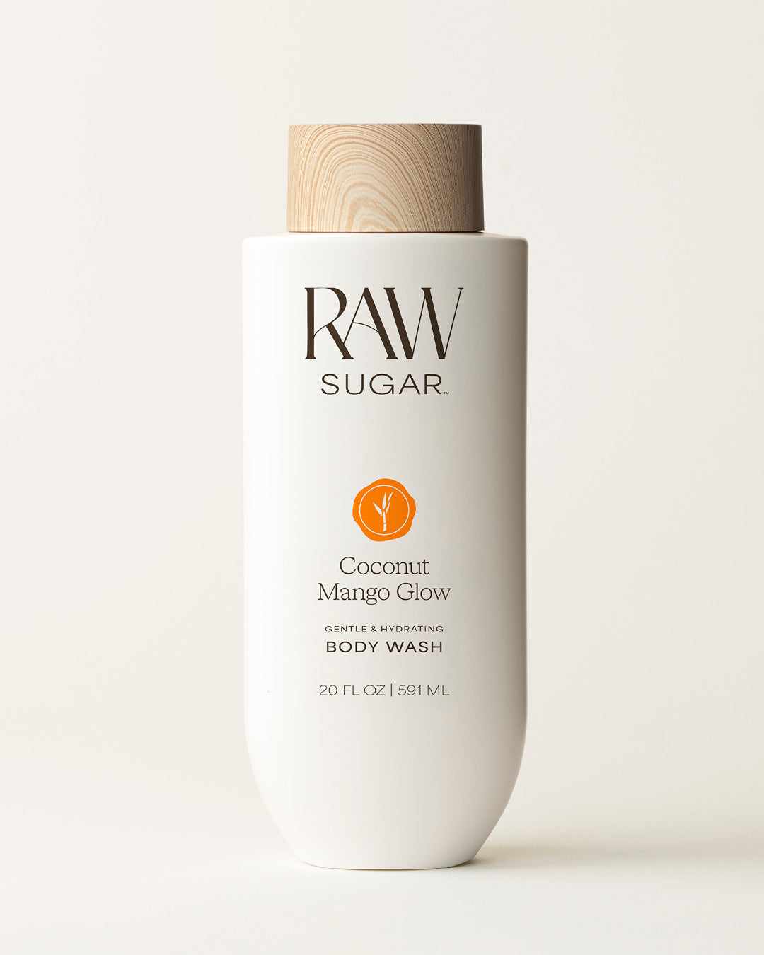 Bottle of Raw Sugar Mango Body Wash on a cream background, designed to help gently cleanse and hydrate skin with clean ingredients.