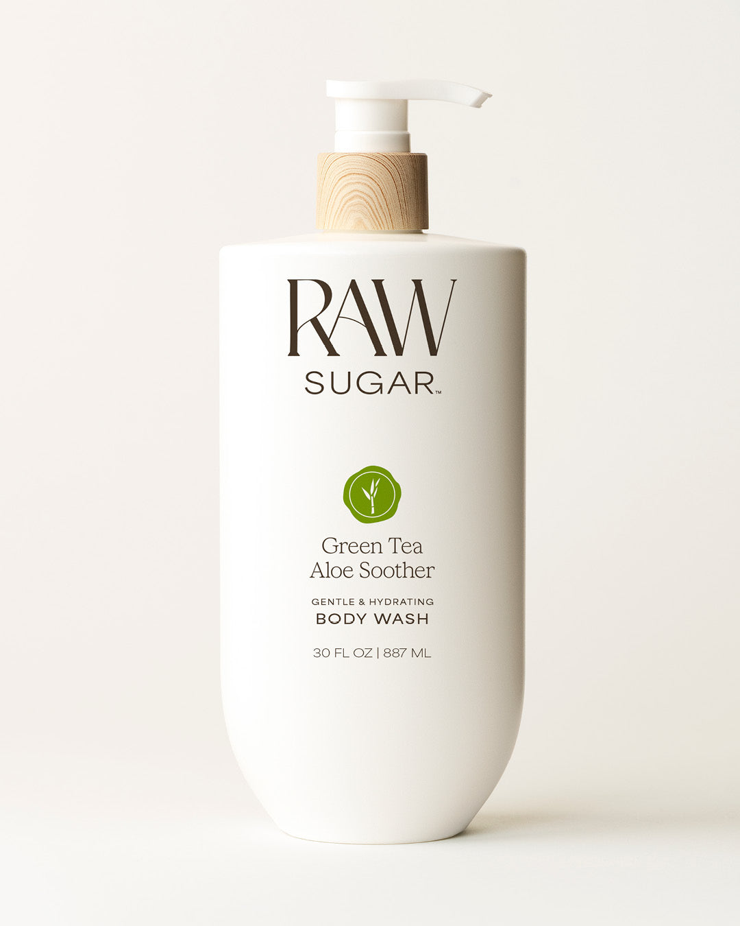 Bottle of Raw Sugar Green Tea Body Wash on a cream background, designed to help gently cleanse and hydrate skin with clean ingredients.