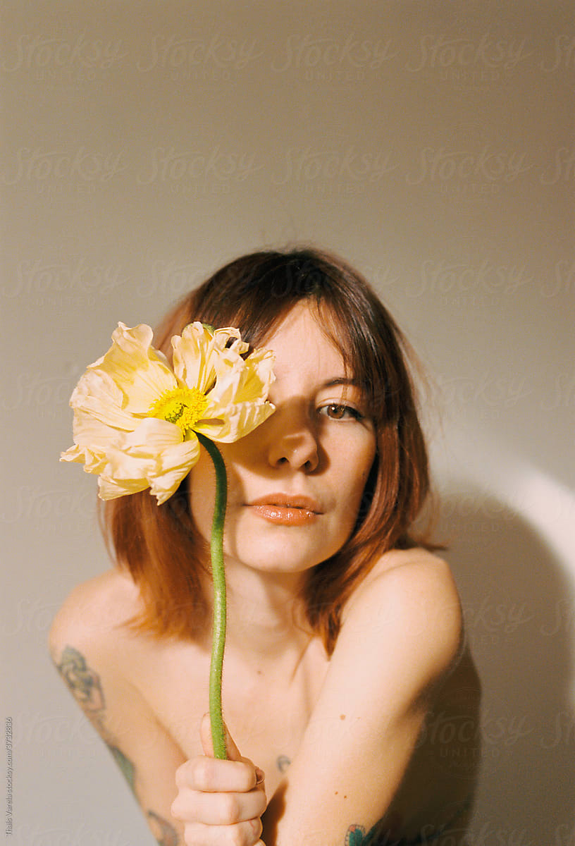 Woman Holding Flower in Front of Face