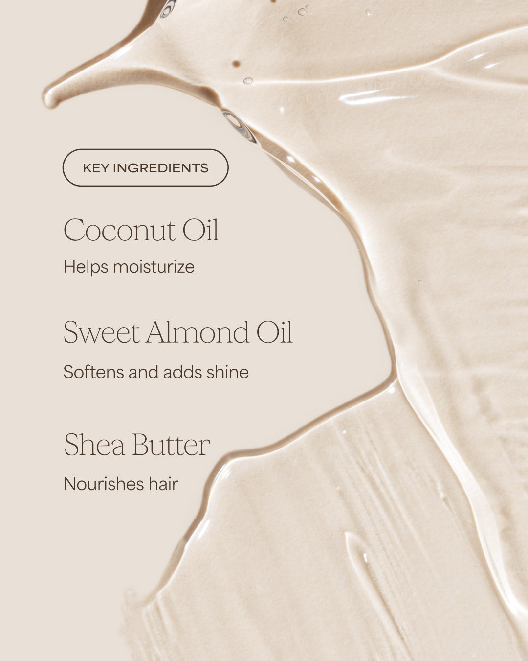 Close-up of a smooth, beige surface with text detailing key ingredients of a hair care product.